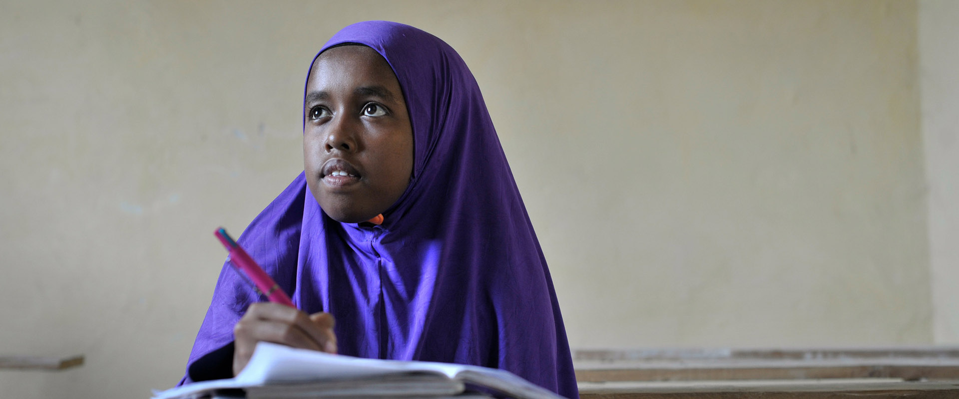 Young girl taking notes